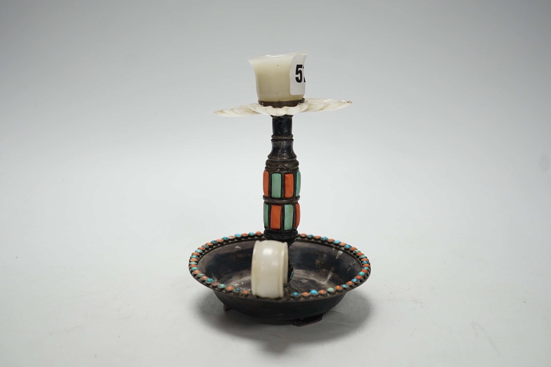 A Chinese white metal jade, coral and turquoise mounted chamberstick, late 19th century, the jade possibly earlier 15cm